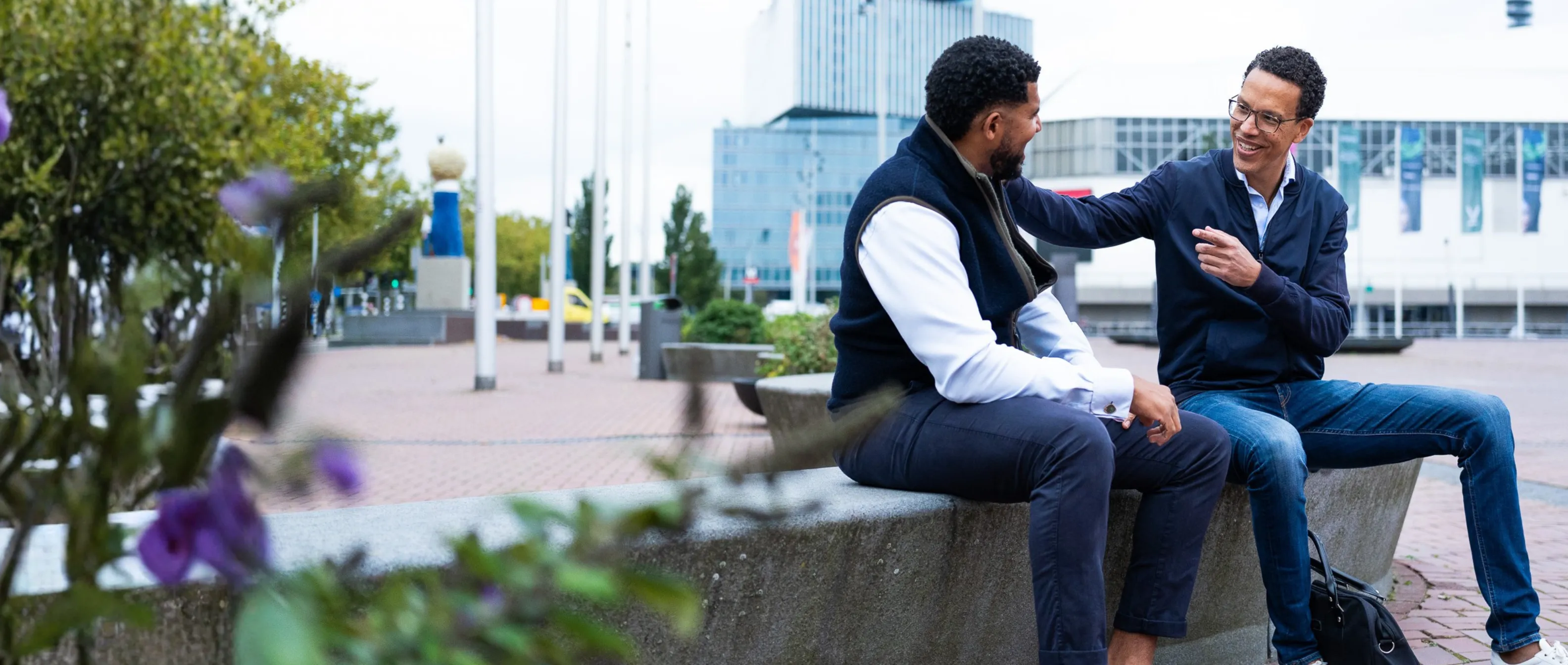 Two auditors talking outside an office building