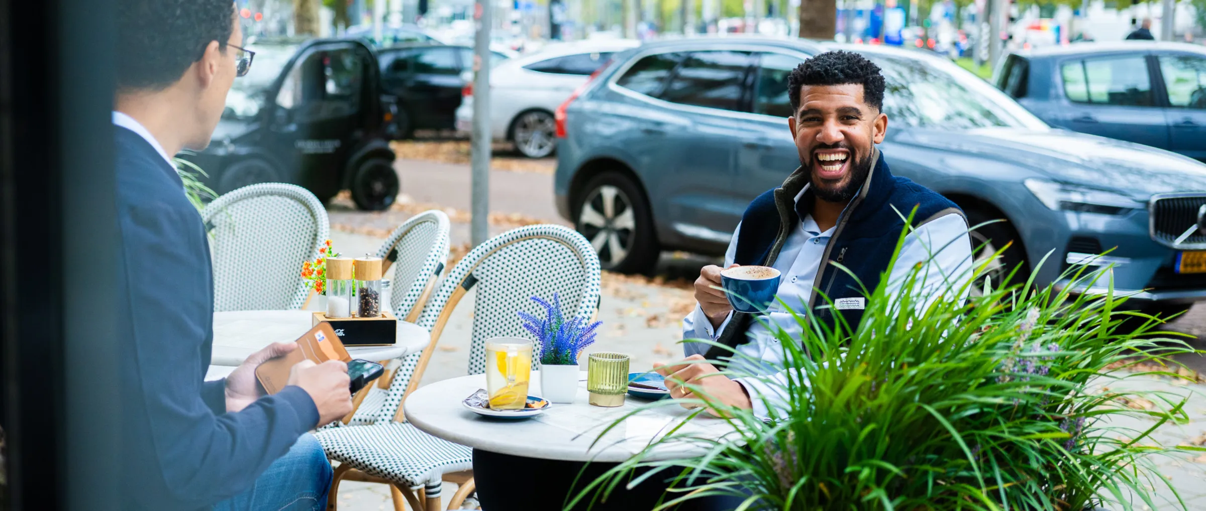 Two auditors in conversation on a terrace